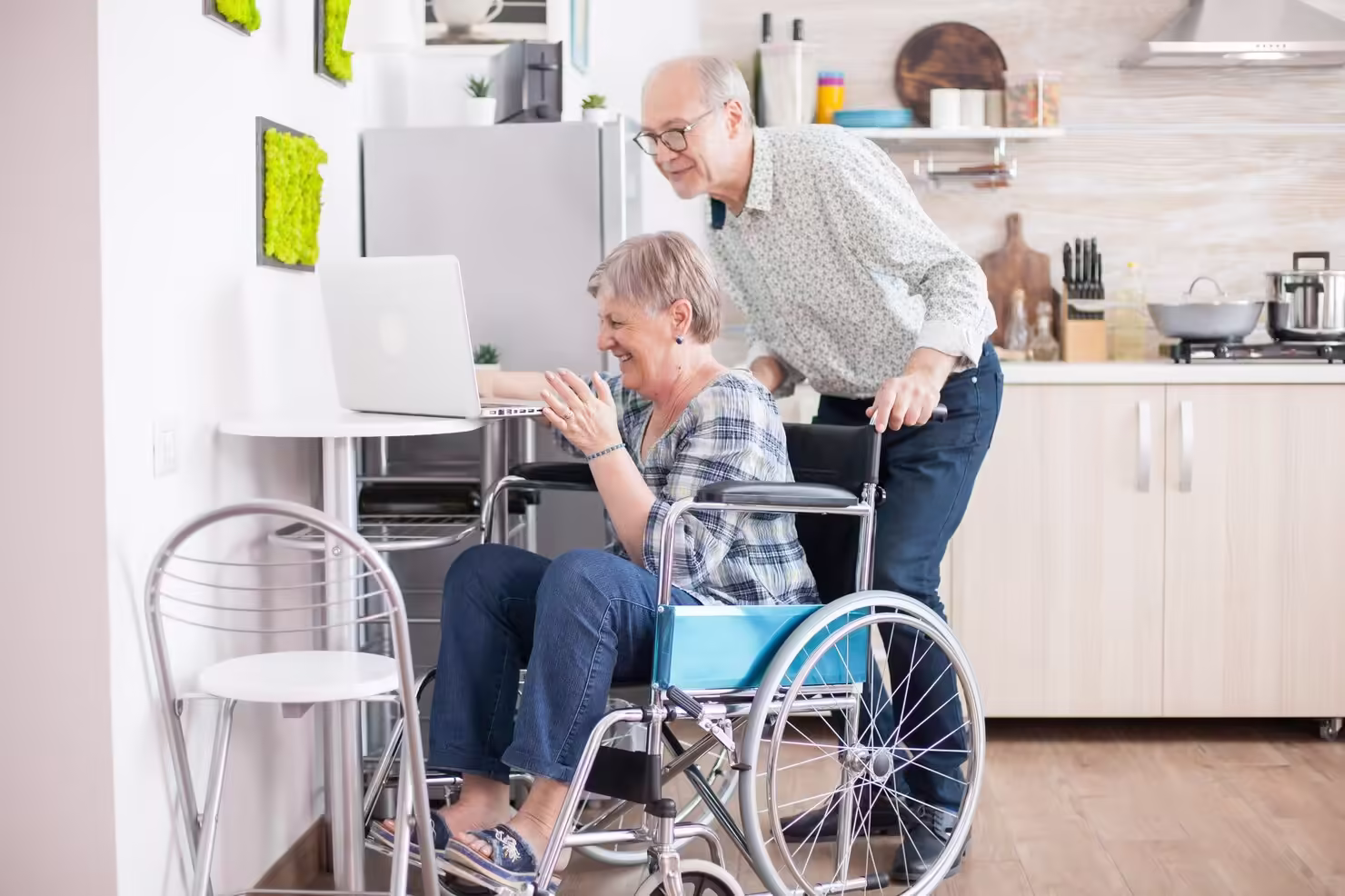 Senior woman in wheelchair on video call .