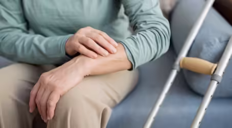 A man holding his arm.