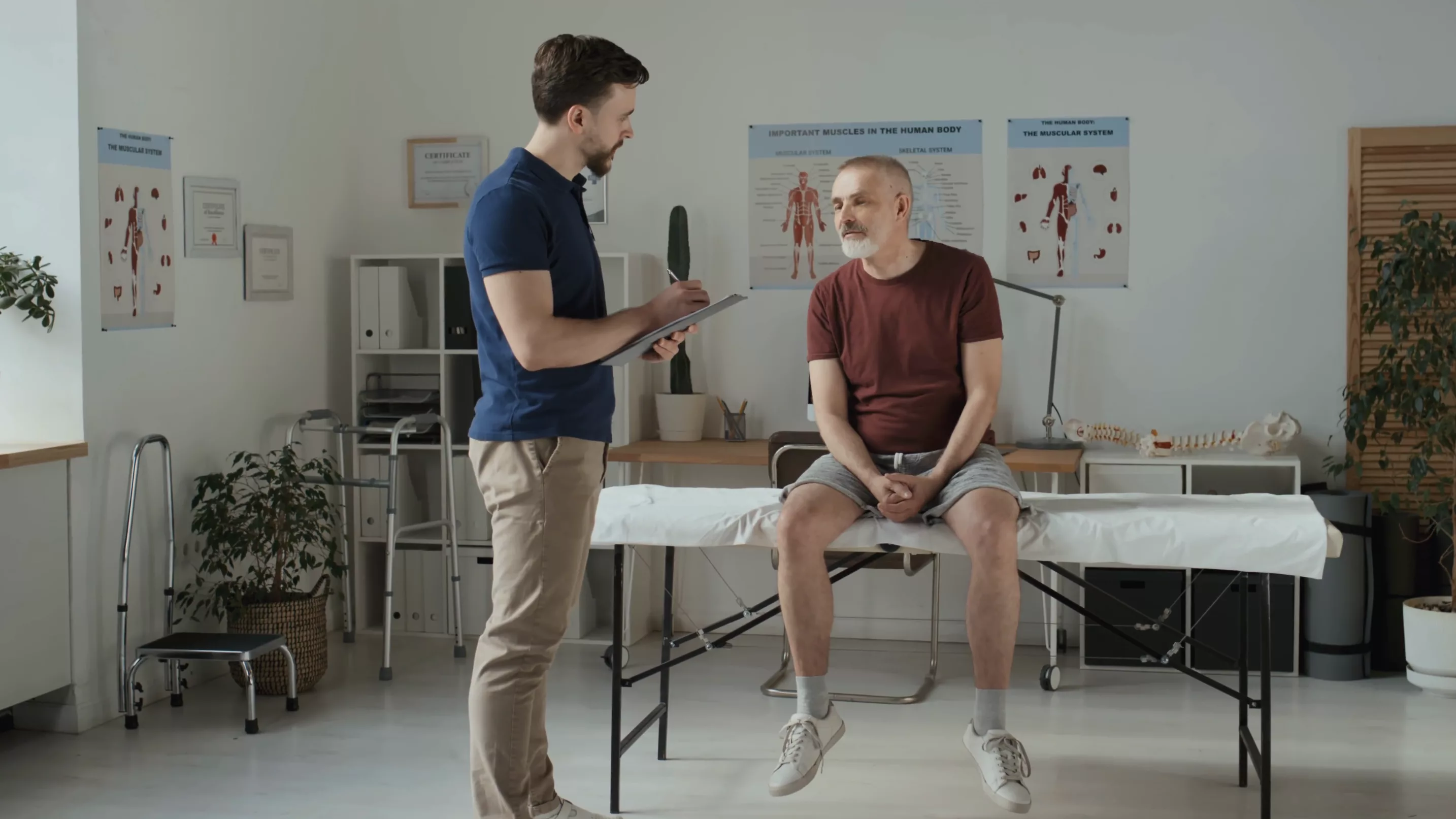 Physiotherapist Consulting the patient about the back pain